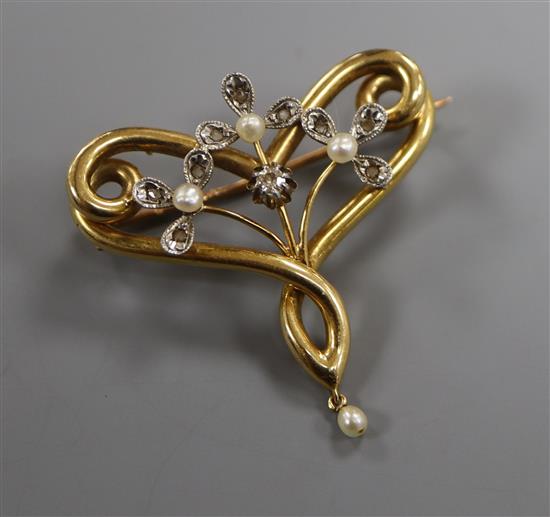 A yellow metal, diamond and seed pearl scrolled openwork brooch, with pearl drop, Tessier box, 35mm width.